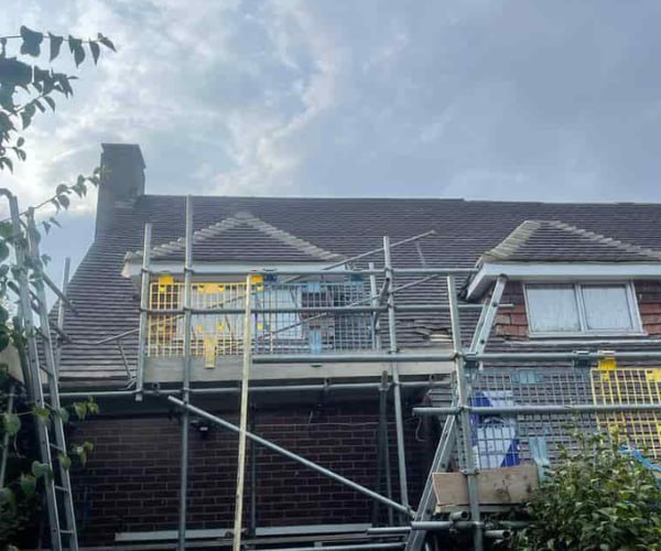 This is a photo of a roof with two dormers that is having some damaged tiles replaced. Works carried out by WS Roofing South Elmsall